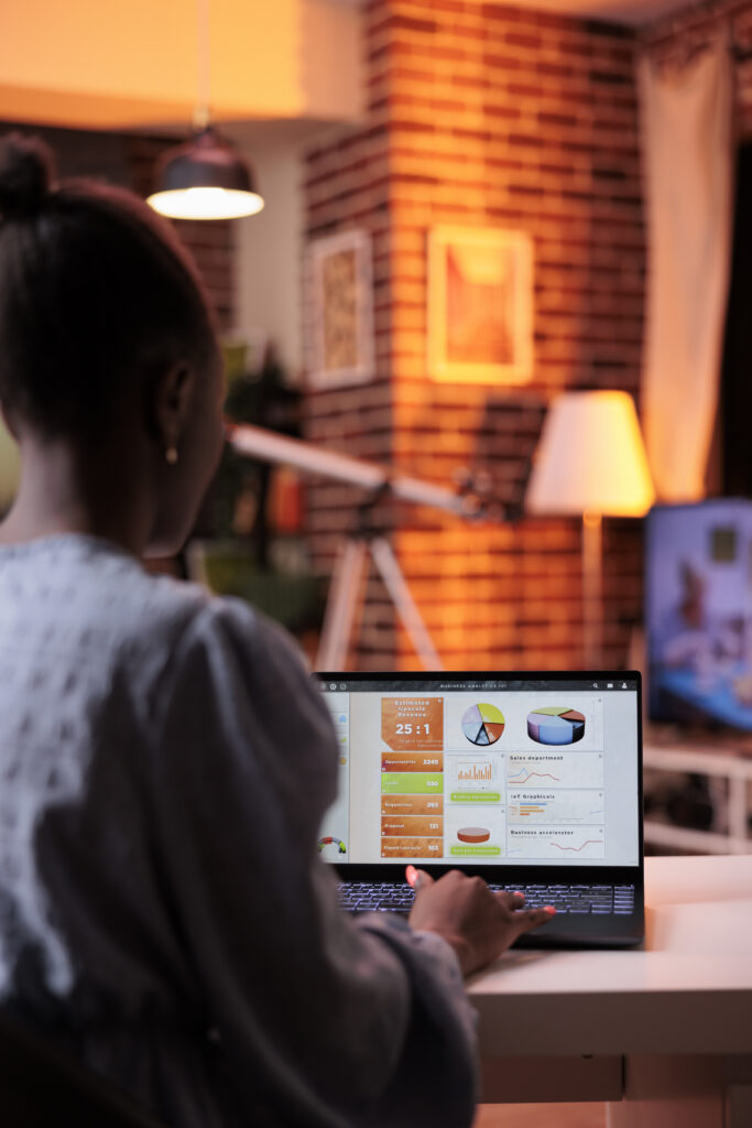 business analyst looking at diagrams and pie charts on laptop screen